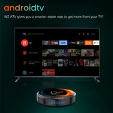 Smart TV with streaming platform interface and sleek round media player device on green background