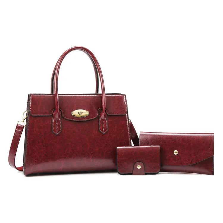 Set of burgundy faux leather handbags and wallets with gold-tone hardware, structured fit