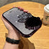 Hand holding a silver glitter astronaut phone case with 3D detailing and glossy finish