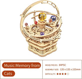 Ornate wooden music box model kit with colorful crystal spheres and planetary design, 84 pieces.