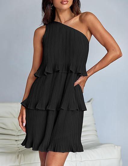Woman wearing a black pleated one-shoulder ruffle mini dress, relaxed fit, indoor setting