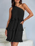 Woman wearing a black pleated one-shoulder ruffle mini dress, relaxed fit, indoor setting