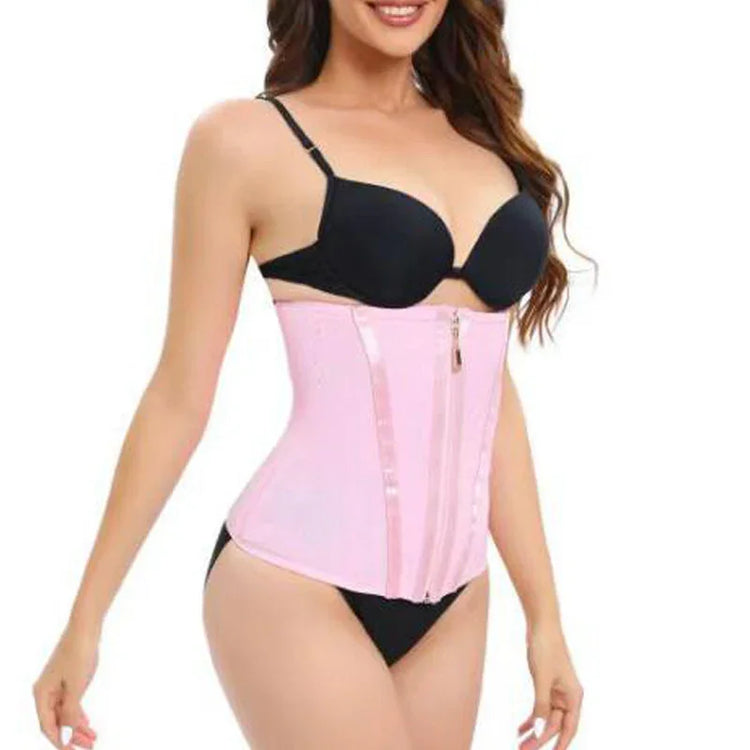 Woman wearing a pink waist trainer corset with zipper, black bra and briefs, slim fit style