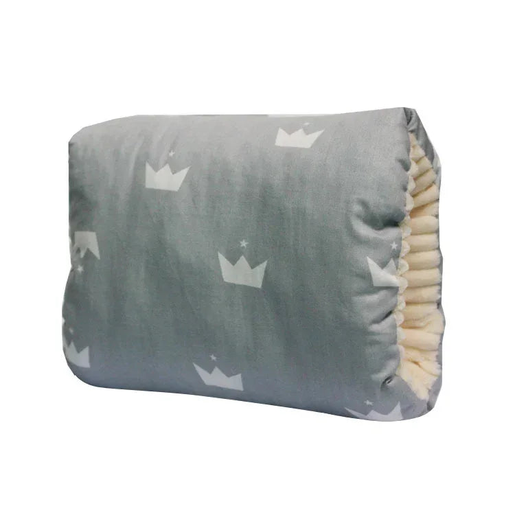 Gray plush pillow with white crown print and soft gathered edges