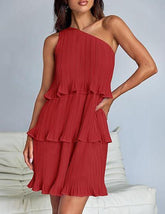 Woman wearing a red pleated one-shoulder ruffle mini dress with a relaxed fit