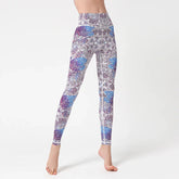 High-waisted fitted leggings with blue and purple mandala pattern on white fabric
