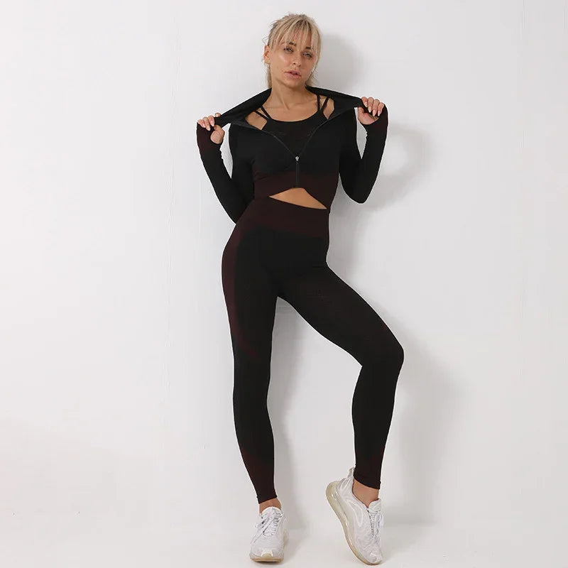 Woman in black fitted athleisure set with high-waisted leggings and zip-up crop jacket