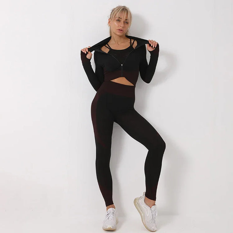 Woman in black fitted athleisure set with high-waisted leggings and zip-up crop jacket