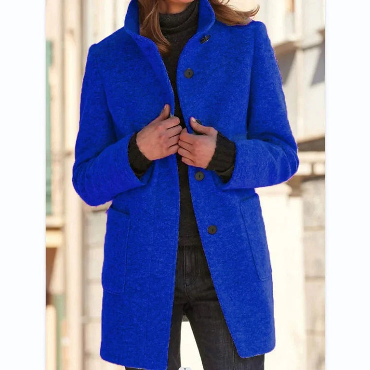 Woman wearing a vibrant blue wool coat with button closure, fitted style, and side pockets