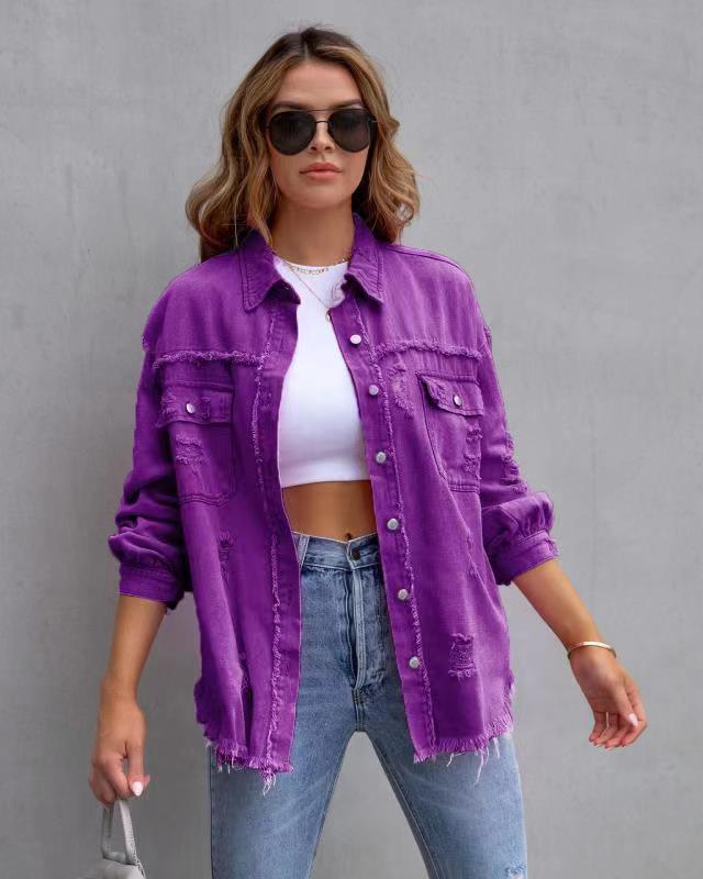 Woman in oversized purple distressed denim jacket, cropped white top, and high-waisted jeans