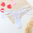 White lace butterfly thong with strappy sides, delicate floral detailing, and sheer material