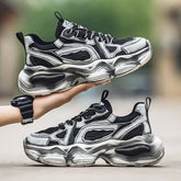 Chunky black and silver futuristic sneakers with mesh panels and thick sculpted soles