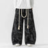 Black tie-dye wide-leg pants with rope belt, loose fit streetwear style.