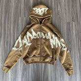 Brown oversized zip-up hoodie with bold white graffiti graphic, fleece material, relaxed fit