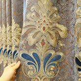 Close-up of gold and blue baroque embroidered velvet curtain with ornate pattern