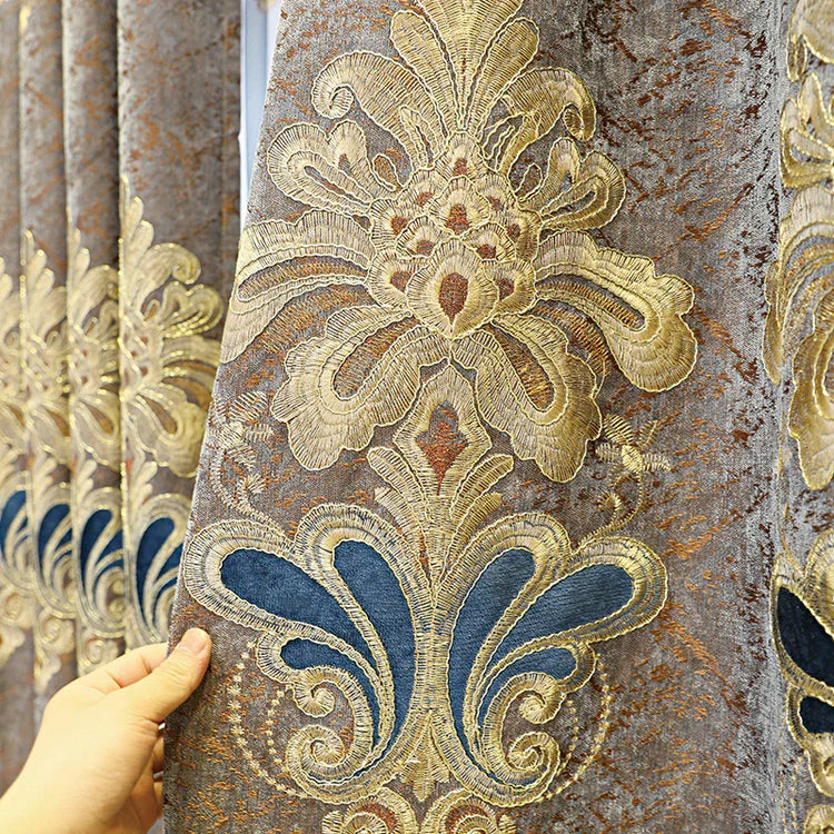 Close-up of gold and blue baroque embroidered velvet curtain with ornate pattern