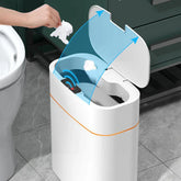 White automatic sensor trash can with blue lid in modern bathroom setting