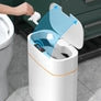 White automatic sensor trash can with blue lid in modern bathroom setting
