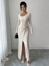 Woman wearing a beige ribbed knit bodycon maxi dress with long sleeves and front slit