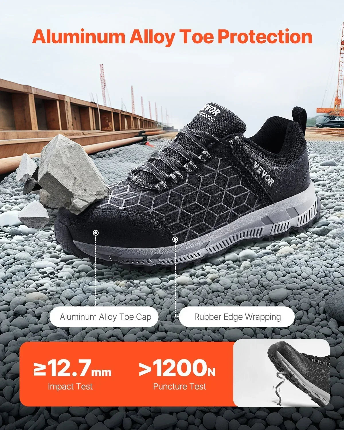 Black geometric steel toe sneaker with rubber sole, mesh upper, and protective cap on gravel.