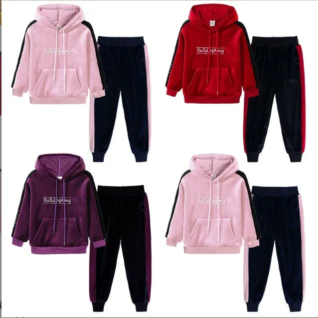 Velour tracksuit sets in pink, red, and purple with hoodies and jogger pants, color-block design.