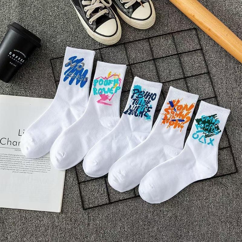White crew socks with colorful abstract graffiti designs, cotton streetwear, casual fit