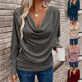 Woman wearing a long sleeve draped cowl neck top in multiple colors, relaxed fit, casual style.