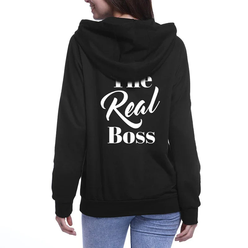Woman wearing black hoodie with &