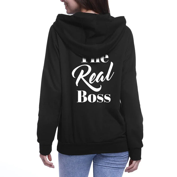 Woman wearing black hoodie with &