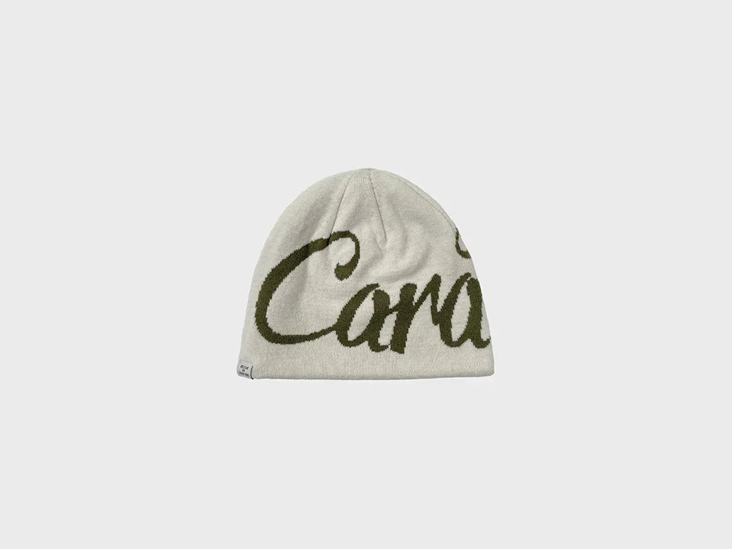 Light grey knit beanie with dark green script lettering, soft material, relaxed fit