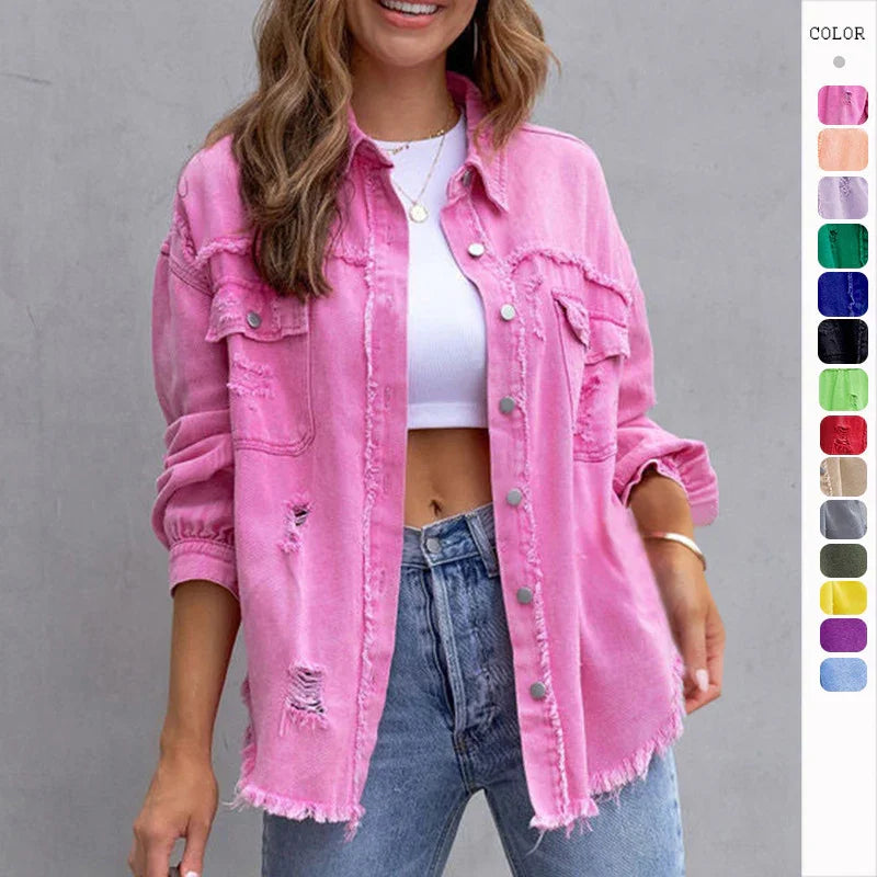 Woman wearing oversized pink distressed denim jacket with frayed edges and ripped details