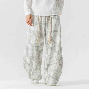 Wide-leg gray tie-dye pants with drawstring waist, loose fit, and soft fabric for streetwear style