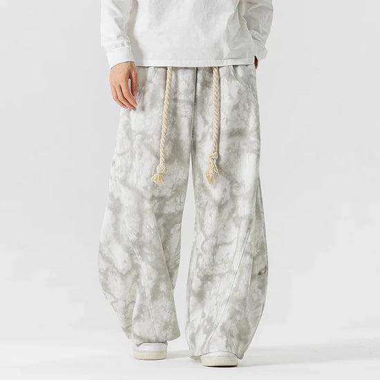 Wide-leg gray tie-dye pants with drawstring waist, loose fit, and soft fabric for streetwear style