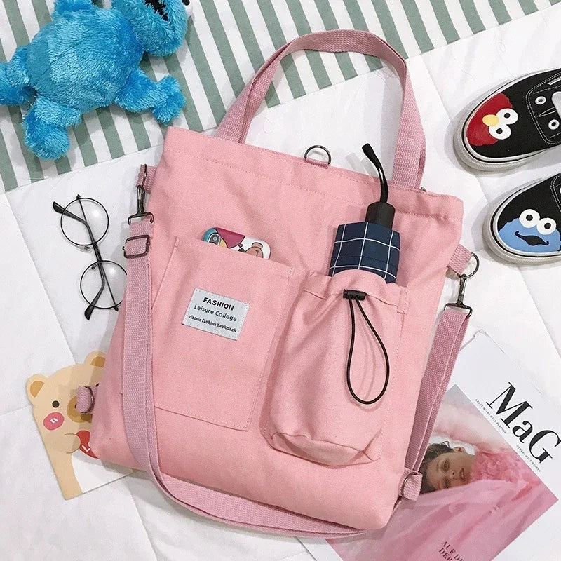 Pastel pink canvas tote bag with pockets, adjustable strap, casual streetwear style