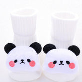 White plush baby socks with cute panda bear faces, soft material, cozy fit