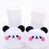 White plush baby socks with cute panda bear faces, soft material, cozy fit