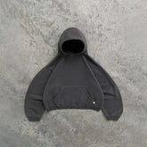 Oversized dark grey hoodie with kangaroo pocket and relaxed fit on concrete background