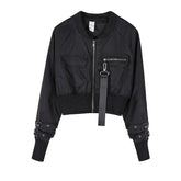 Black cropped bomber jacket with front zipper, utility pockets, buckle straps on sleeves, and relaxed fit