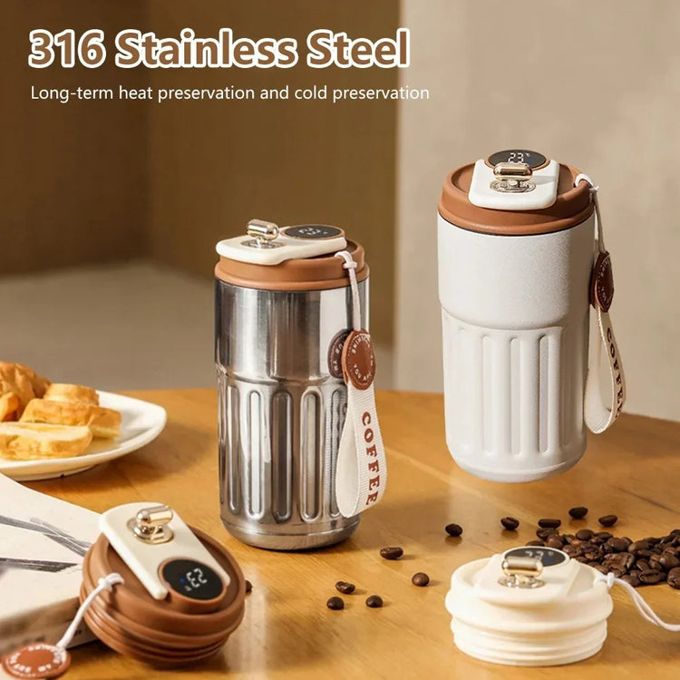 Double wall stainless steel and white insulated tumblers with digital temperature display lids, coffee-themed straps, and a modern, textured finish for hot and cold drinks.