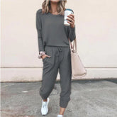 Woman in gray long sleeve lounge set with jogger pants, relaxed fit, white sneakers