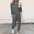 Woman in gray long sleeve lounge set with jogger pants, relaxed fit, white sneakers