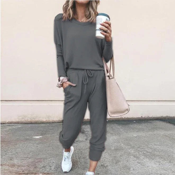 Woman in gray long sleeve lounge set with jogger pants, relaxed fit, white sneakers