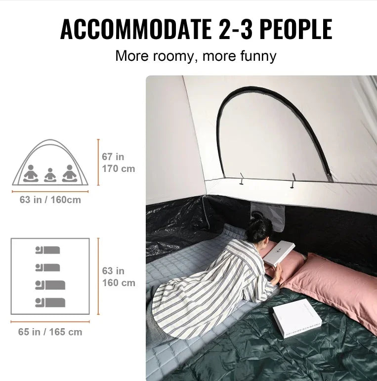 Woman in loose striped loungewear reading inside roomy tent with padded sleeping mats.