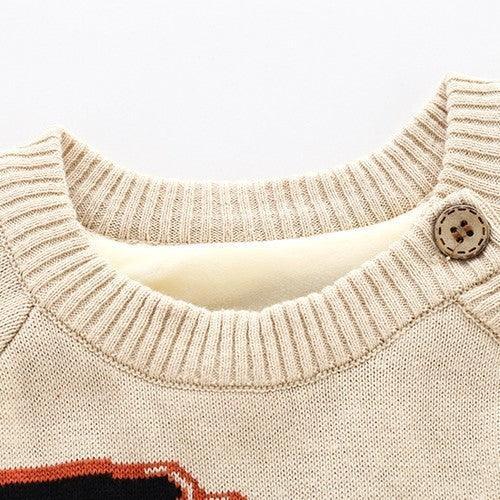 Beige knitted crewneck sweater with ribbed collar and decorative button detail, close-up
