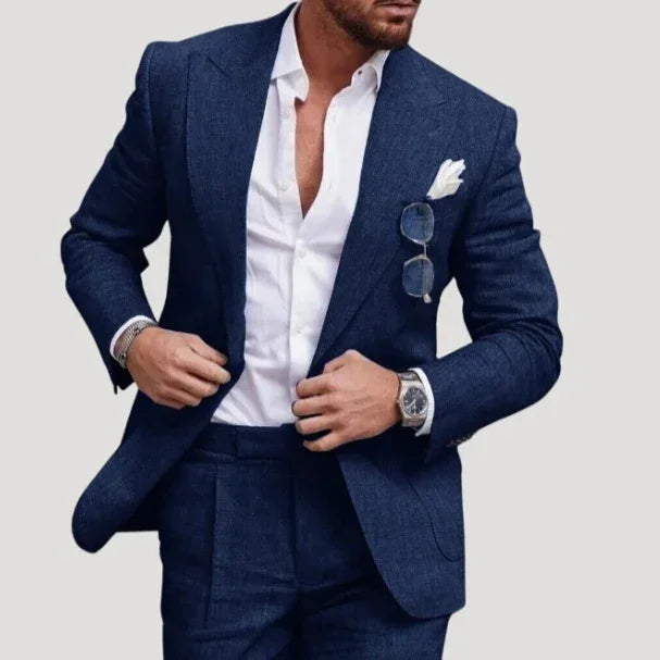 Man wearing tailored dark blue suit, white dress shirt, slim fit, with pocket square