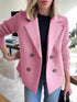 Woman wearing a pink double-breasted wool blazer with ribbed knit sleeves, paired with jeans