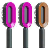 Three oval hair brushes with black handles and pink or brown glossy plastic frames