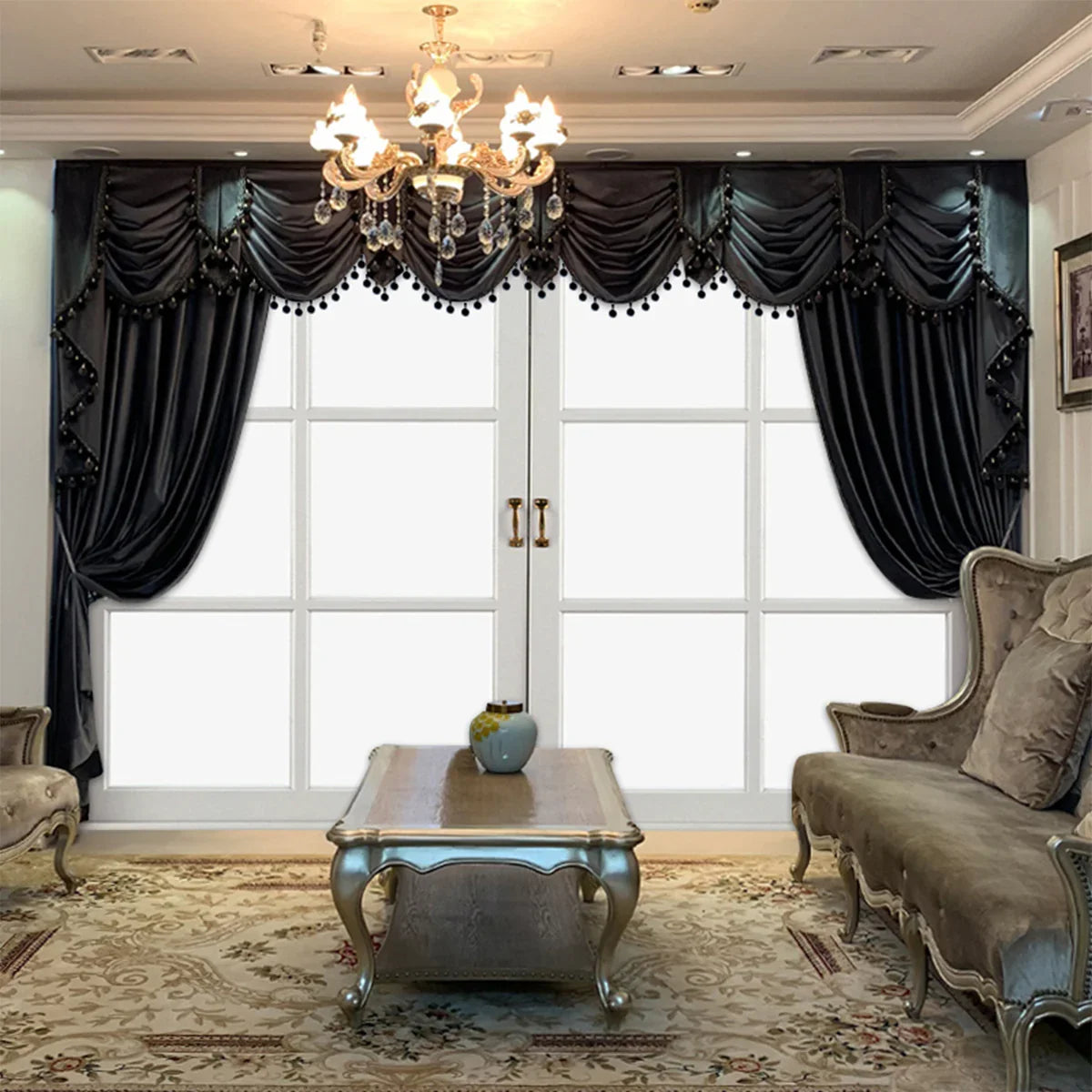 Elegant living room with dark velvet draped curtains, tufted beige sofas, ornate coffee table, and chandelier