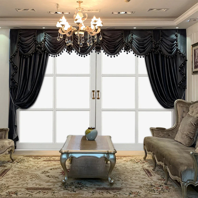 Luxurious living room with dark velvet curtains, ornate sofa set, and chandelier lighting.