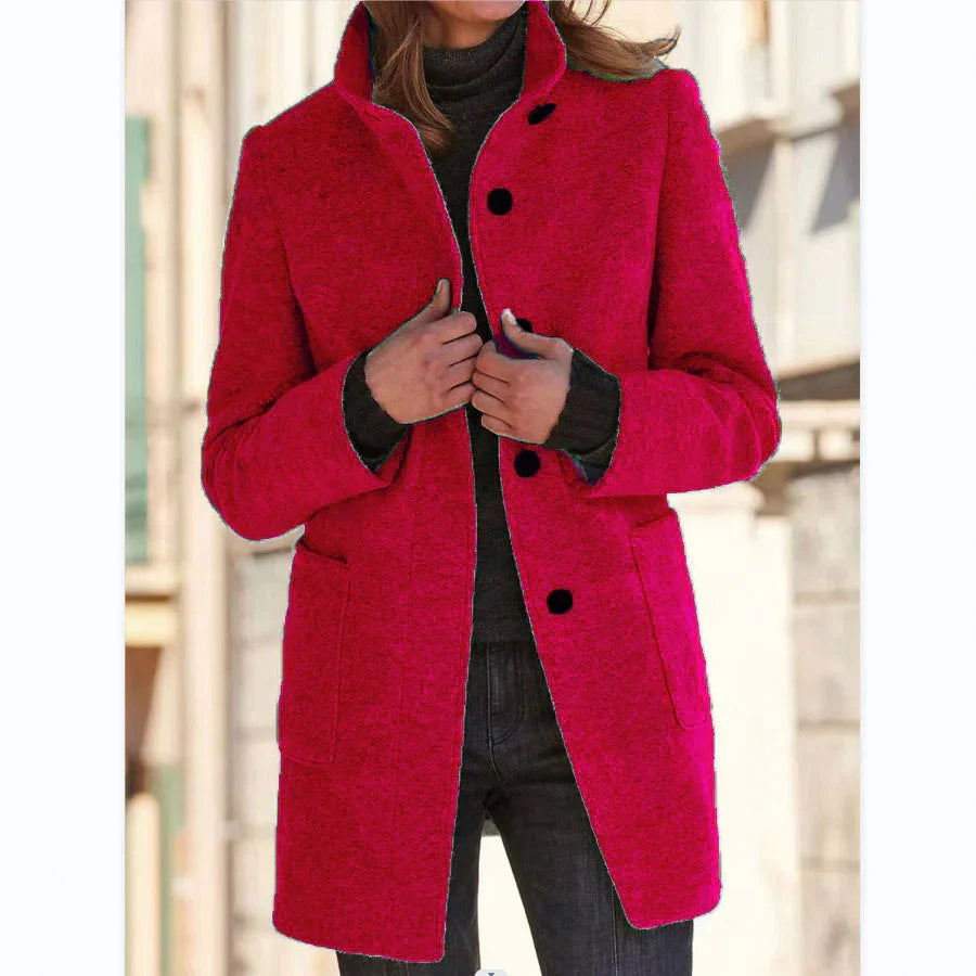 Woman wearing a vibrant red wool coat with black buttons, slim fit, street style fashion